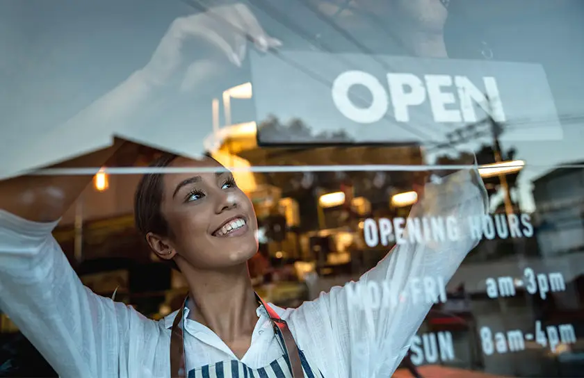 A person opening their business for the first time representing the best ways to grow a business in 2024