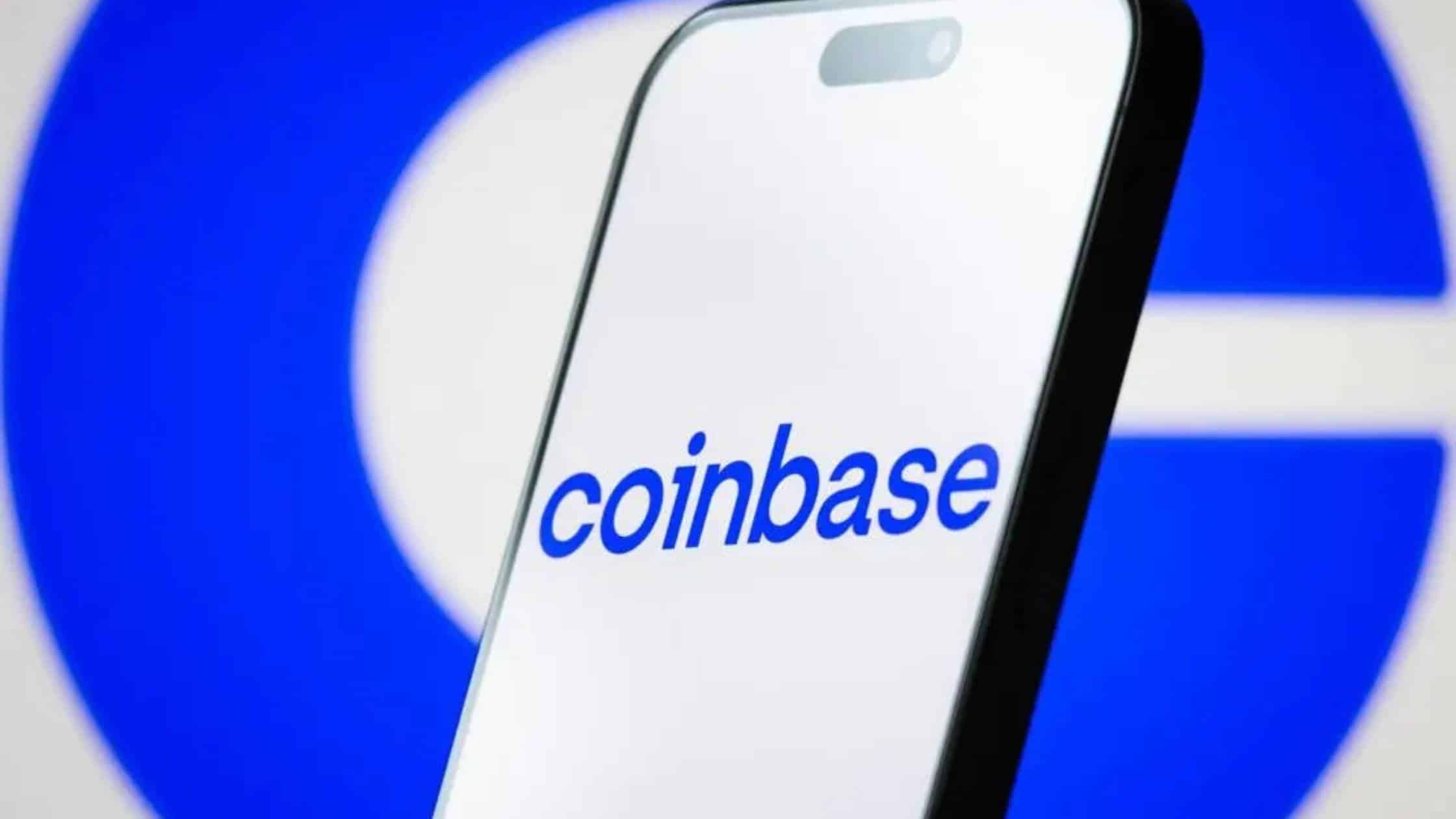 A person holding a smartphone displaying the Coinbase app with a live cryptocurrency price chart.