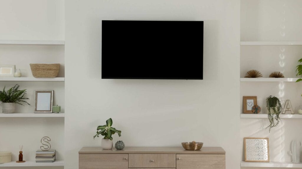 A mounted TV on a clean wall, showcasing handyman side hustles like professional TV mounting services.