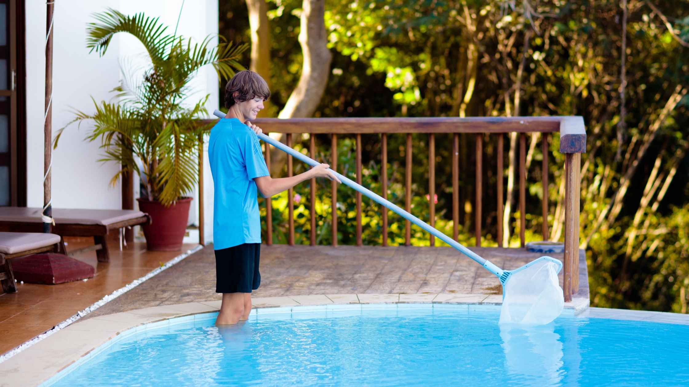 Young man cleaning a swimming pool as one of many spring side hustle ideas