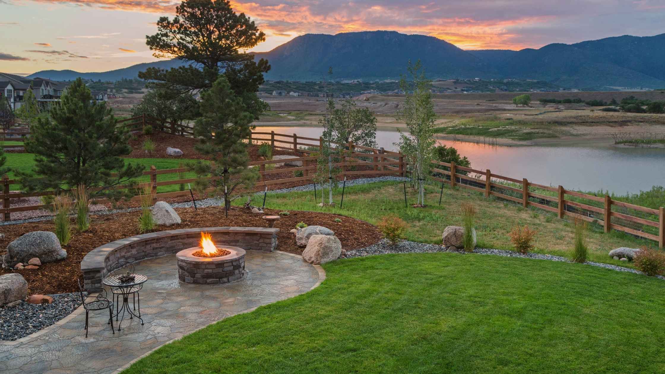 DIY backyard design with custom stone fire pit and sunset mountain view
