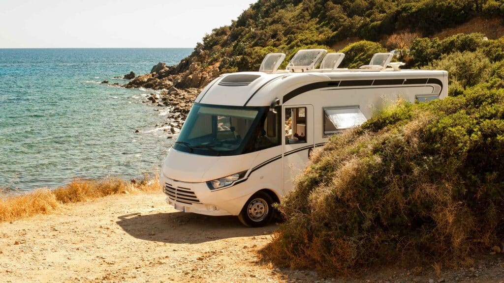 Modern RV parked by the ocean representing the freedom of RV business