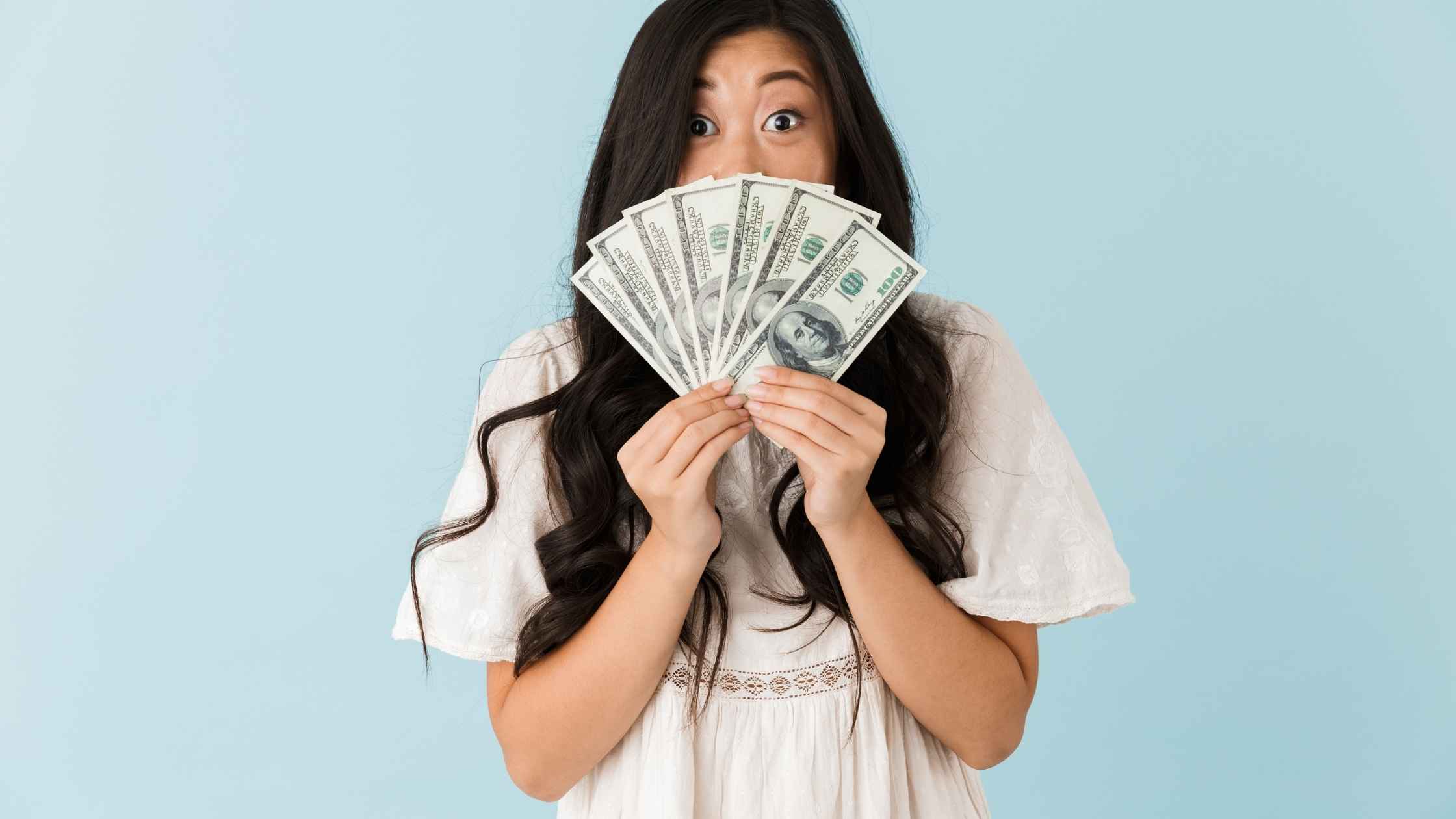 Student holding cash excitedly — representing smart money management for students