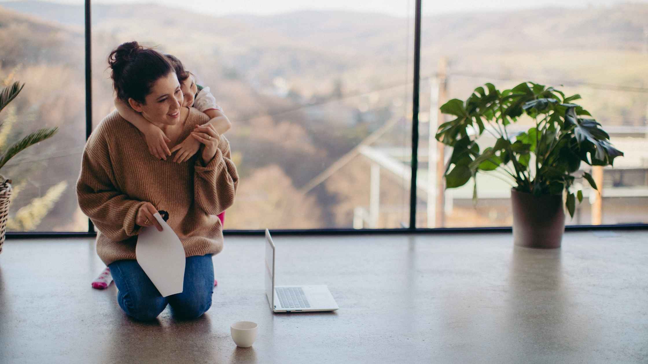 Mother and child at home with laptop — can you work from home without a degree?