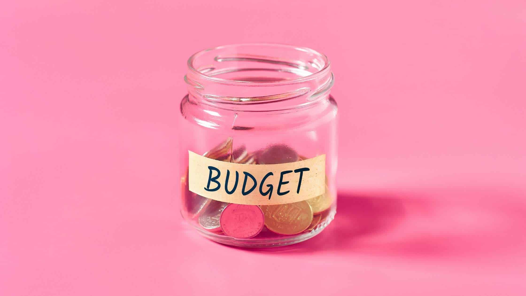 A jar with tape around it, which has "Budget" written in bold letters on it representing how to make a budget based on personal finances.