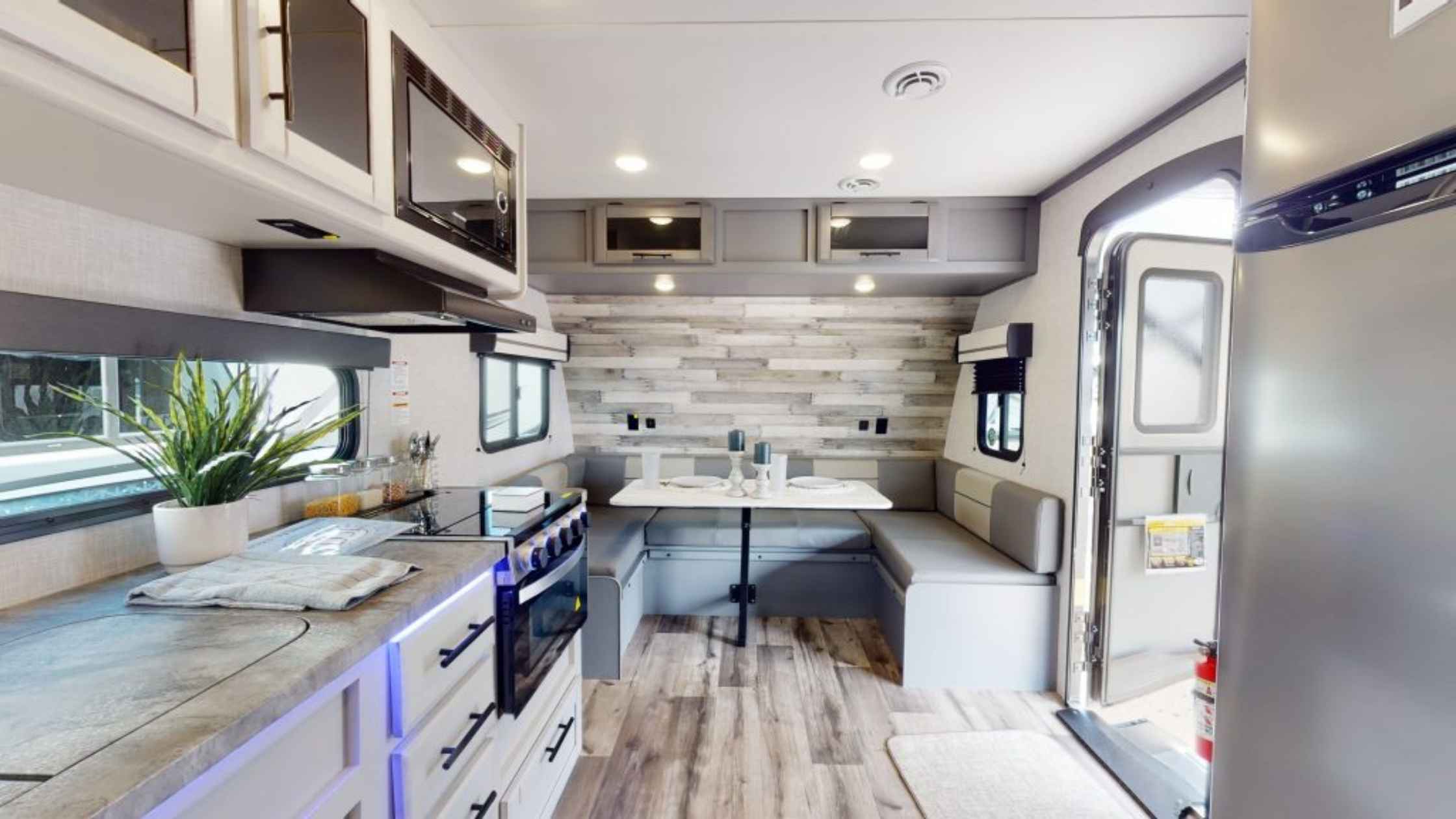 Modern RV kitchen and dining area makeover showcasing rv renovation ideas on a budget.