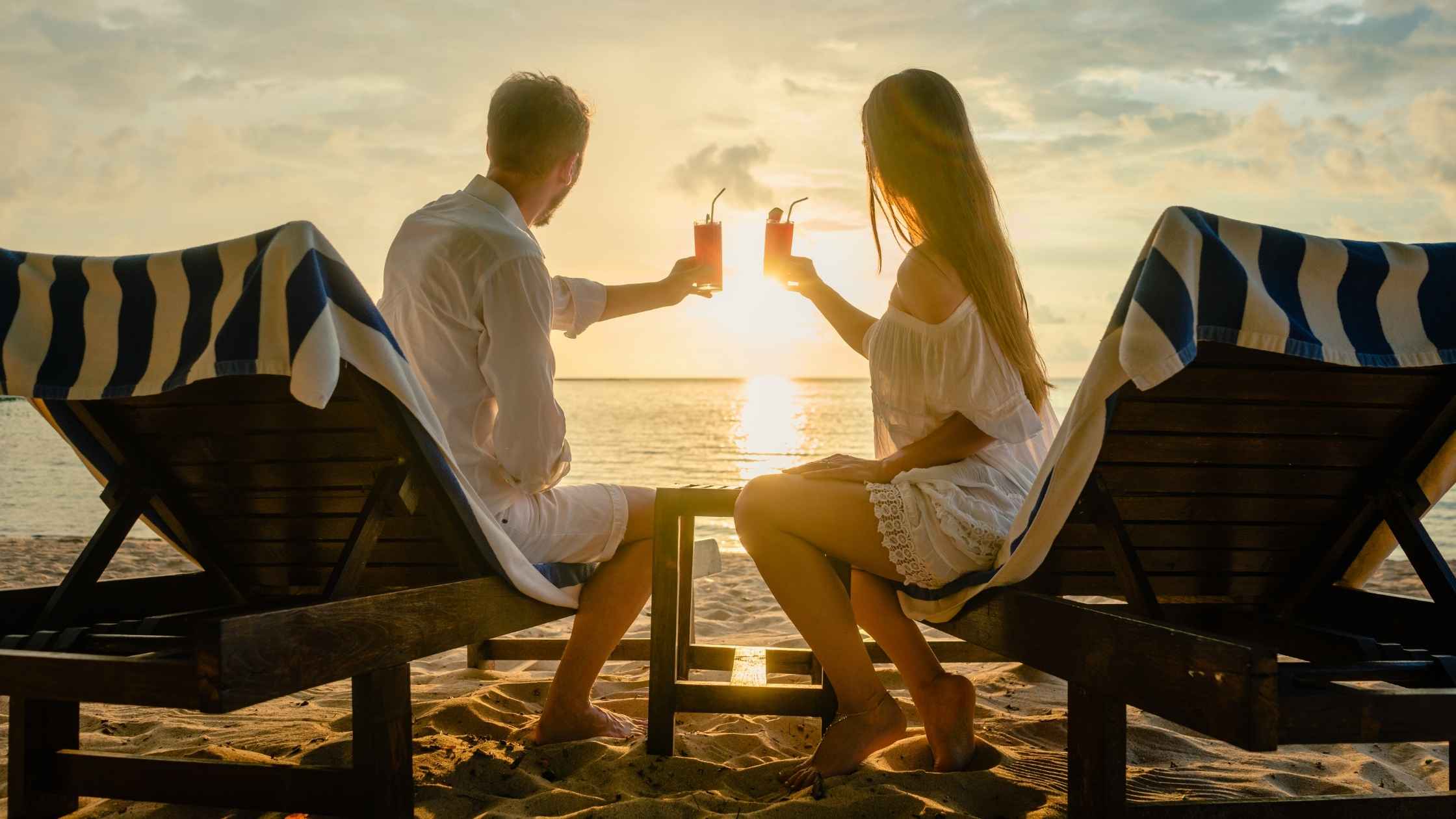 Couple enjoying a sunset beach moment as part of romantic date planning inspo