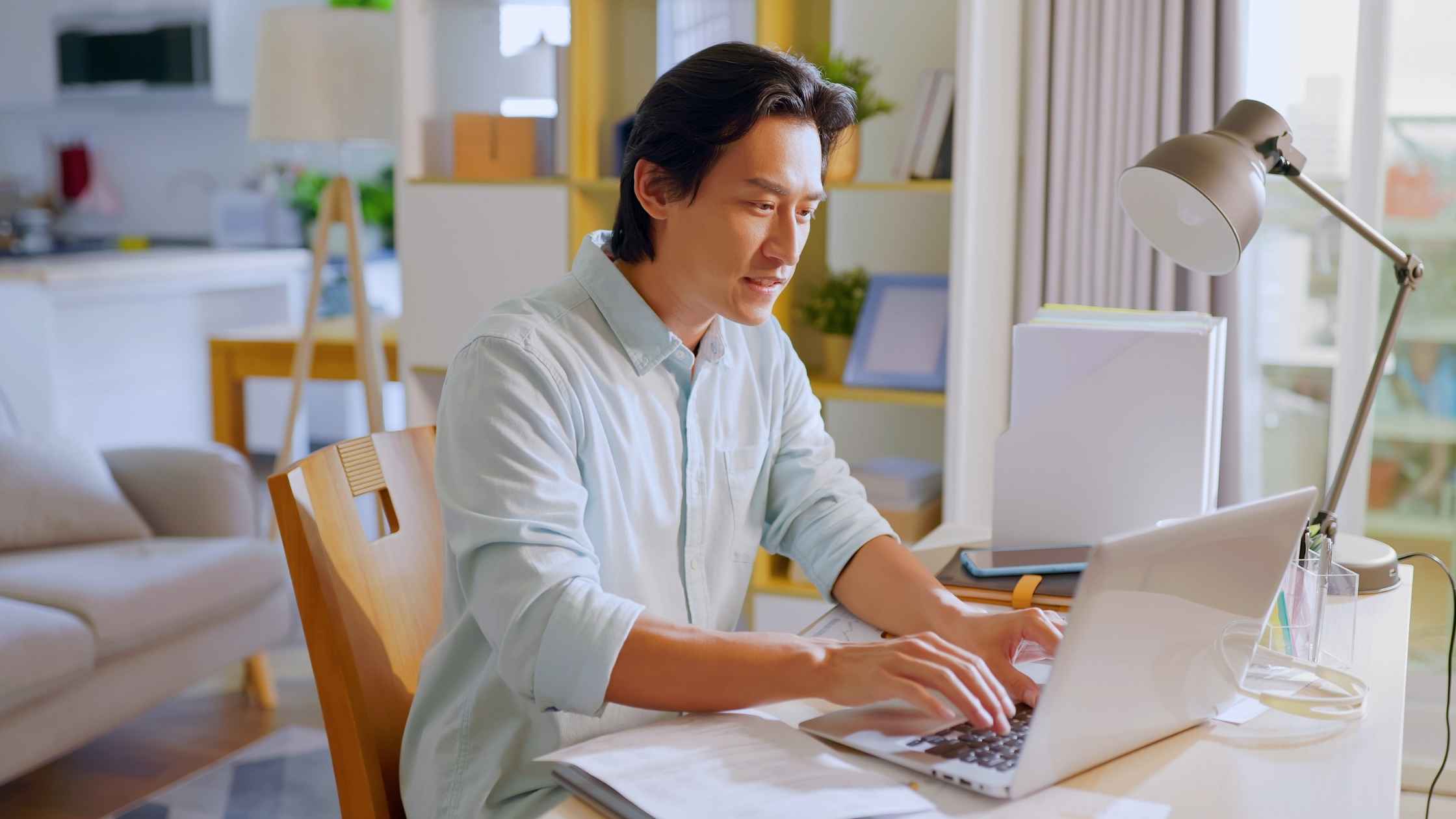 Man working from home on laptop representing the easiest work at home jobs that require zero experience