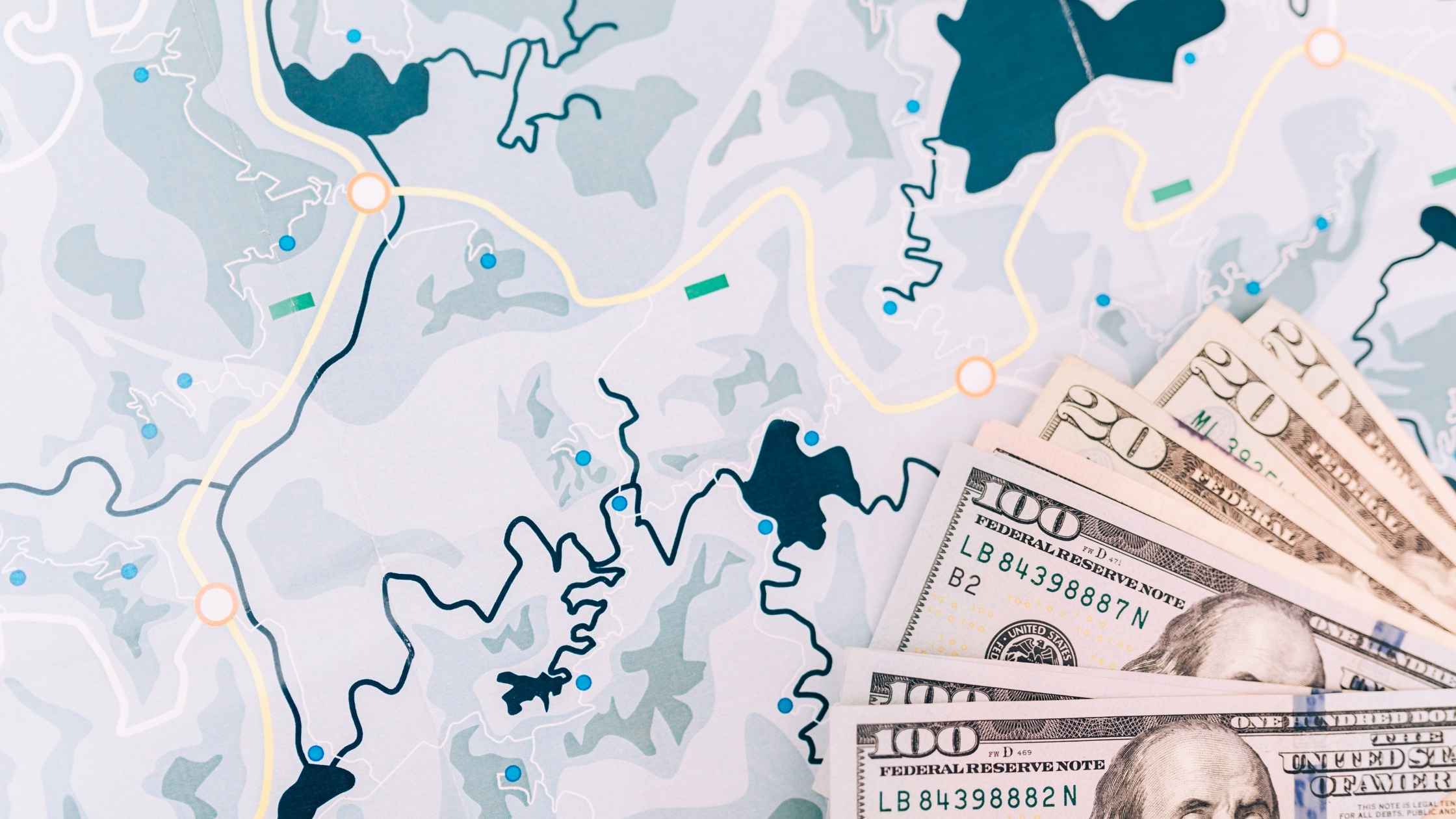 Map with cash bills symbolizing travel budgeting and trip planning